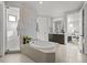 Bright main bathroom boasts a soaking tub, separate shower, and double vanity at 9487 Winding Hill Way, Lone Tree, CO 80124