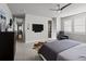Comfortable main bedroom with wall mounted TV, access to en-suite bath, and plenty of natural light at 9487 Winding Hill Way, Lone Tree, CO 80124