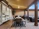 Covered patio featuring a dining table, an outdoor kitchen, and additional seating at 9487 Winding Hill Way, Lone Tree, CO 80124