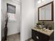 Elegant powder room features a vessel sink and modern fixtures at 9487 Winding Hill Way, Lone Tree, CO 80124
