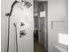 Modern shower with tiled walls, rainfall shower head, and glass door at 9487 Winding Hill Way, Lone Tree, CO 80124