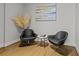 Sitting area featuring hardwood floors and two modern black chairs at 9487 Winding Hill Way, Lone Tree, CO 80124