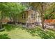 Backyard featuring a landscaped lawn and the exterior of a brick home at 650 Saint Paul St, Denver, CO 80206