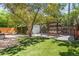 Backyard featuring multiple gathering areas, including artificial turf and a pergola at 650 Saint Paul St, Denver, CO 80206