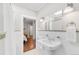 Bright bathroom features a pedestal sink, white tile, and classic fixtures at 650 Saint Paul St, Denver, CO 80206