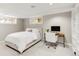 Finished basement bedroom featuring a full bed, desk, and built-in bookshelves at 650 Saint Paul St, Denver, CO 80206