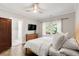 Calm bedroom with ensuite bathroom, hardwood floors, and a view to the exterior at 650 Saint Paul St, Denver, CO 80206