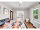 Bright bedroom with a doorway leading into a study space and hardwood floors at 650 Saint Paul St, Denver, CO 80206