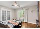Cozy bedroom with natural light, hardwood floors, and a ceiling fan at 650 Saint Paul St, Denver, CO 80206
