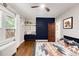Comfortable bedroom with blue accent wall, hardwood floors, and a built-in nook at 650 Saint Paul St, Denver, CO 80206