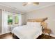 Bright bedroom featuring a live edge wood headboard, ceiling fan, and hardwood floors at 650 Saint Paul St, Denver, CO 80206