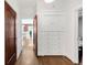 Hallway with hardwood floors and built-in storage at 650 Saint Paul St, Denver, CO 80206