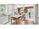 Bright kitchen with exposed brick, stainless steel appliances, and kitchen island at 650 Saint Paul St, Denver, CO 80206