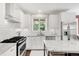 Bright kitchen with granite countertops, subway tile backsplash, and stainless steel appliances at 650 Saint Paul St, Denver, CO 80206