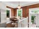 Cozy eat-in kitchen with exposed brick wall and stainless steel appliances at 650 Saint Paul St, Denver, CO 80206