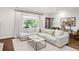 Comfortable living room with a large sectional sofa and bright natural lighting from large windows at 650 Saint Paul St, Denver, CO 80206