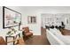 Open-concept living room with hardwood floors and views of the dining and kitchen area at 650 Saint Paul St, Denver, CO 80206