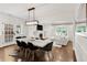 Open-concept living room with hardwood floors, fireplace, and large windows at 650 Saint Paul St, Denver, CO 80206