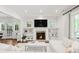 Bright living room featuring a fireplace, built-in shelving, and large windows at 650 Saint Paul St, Denver, CO 80206
