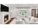 Cozy living room with a modern fireplace and plush seating, filled with natural light at 650 Saint Paul St, Denver, CO 80206