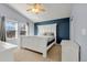 Blue bedroom features a bed with white wooden frame, vaulted ceiling with a fan and windows at 2655 S Jebel Way, Aurora, CO 80013