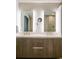 Modern bathroom with double vanity, lighted mirrors, and wood cabinets at 4200 W 17Th Ave # 53, Denver, CO 80204