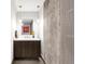 Modern bathroom featuring a sleek vanity, textured wall, and stylish fixtures at 4200 W 17Th Ave # 53, Denver, CO 80204