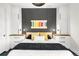 Cozy bedroom featuring built-in cabinets, striped wallpaper, and stylish lighting fixtures at 4200 W 17Th Ave # 53, Denver, CO 80204