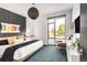 This bedroom features a large window, art, and stylish decor at 4200 W 17Th Ave # 53, Denver, CO 80204