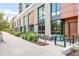 Contemporary building with brick and wood facade, inviting outdoor seating, and well-maintained landscaping at 4200 W 17Th Ave # 53, Denver, CO 80204