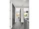 Hallway with access to rooms filled with natural light, modern railings, and neutral-toned decor at 4200 W 17Th Ave # 53, Denver, CO 80204