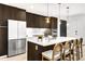 Modern kitchen featuring stainless steel appliances, stylish lighting, and dark wood cabinetry at 4200 W 17Th Ave # 53, Denver, CO 80204