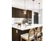 Sleek kitchen island with modern pendant lights, stainless steel faucet, and seating for casual dining at 4200 W 17Th Ave # 53, Denver, CO 80204