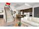 Inviting living area with open staircase, kitchen view, and contemporary decor at 4200 W 17Th Ave # 53, Denver, CO 80204