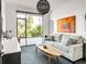 Living room featuring large window, stylish furniture, and modern art at 4200 W 17Th Ave # 53, Denver, CO 80204