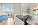 Elegant dining area with modern chandelier, a large dining table, and light-filled windows at 410 Acoma St # 309, Denver, CO 80204