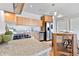 Well-lit kitchen featuring granite countertops, stainless steel appliances, wood cabinets, and hardwood flooring at 410 Acoma St # 309, Denver, CO 80204
