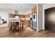 Modern kitchen features light wood cabinets, a breakfast bar with stools, and stainless steel appliances at 410 Acoma St # 309, Denver, CO 80204
