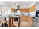 Modern kitchen with wooden cabinets, stainless steel appliances, and center island at 410 Acoma St # 309, Denver, CO 80204