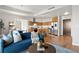 View of an open concept living and kitchen space featuring stainless steel appliances and hardwood floors at 410 Acoma St # 309, Denver, CO 80204