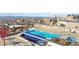 Elevated rooftop pool with tables, lounge chairs and city views at 410 Acoma St # 309, Denver, CO 80204