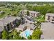 Aerial view of a community with multiple apartment buildings, a pool, and water features at 10787 Twenty Mile Rd # 205, Parker, CO 80134