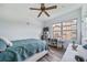 Bedroom with a bed, desk, shelving, and a window with exterior views at 10787 Twenty Mile Rd # 205, Parker, CO 80134