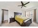 Bedroom with dark furnishings, including a bed with a green cover, and a window at 10787 Twenty Mile Rd # 205, Parker, CO 80134