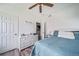 Bedroom with a bed, a chest of drawers, and an adjoining laundry room at 10787 Twenty Mile Rd # 205, Parker, CO 80134
