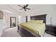 Bright bedroom featuring carpeted floors, ceiling fan, walkout patio, and dark furniture set at 10787 Twenty Mile Rd # 205, Parker, CO 80134