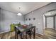 Cozy dining room featuring wood-look floors, modern wall decorations, and a dark wood table with black chairs at 10787 Twenty Mile Rd # 205, Parker, CO 80134