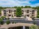 Beautiful condo building featuring well-maintained landscaping, pond, and ample parking for residents and guests at 10787 Twenty Mile Rd # 205, Parker, CO 80134