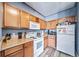 Well-lit kitchen featuring wooden cabinetry, and modern appliances at 10787 Twenty Mile Rd # 205, Parker, CO 80134