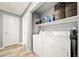 Bright laundry room with a washer, dryer, shelving, and ample storage space at 10787 Twenty Mile Rd # 205, Parker, CO 80134
